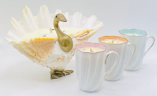 Three vintage porecelain candle cups with a shell in a shape of swan, all hand poured with sustainable wax and pure essential oils by Cockles and Heart Candles